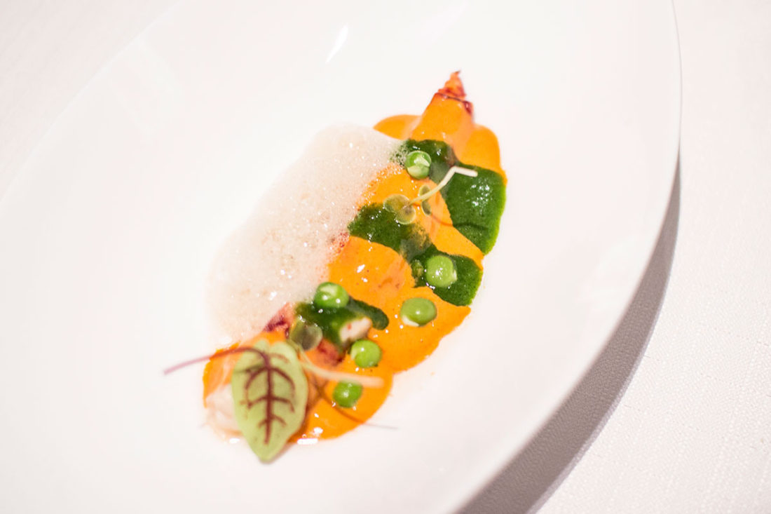 Poached Boston lobster with juices, green peas, and fermented plum vinegar