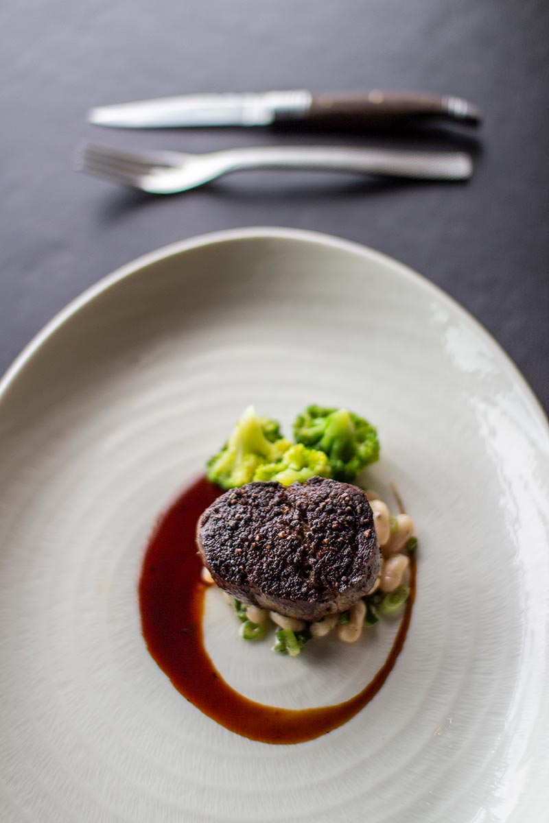 Grilled Black Angus fillet with cannellini beans, spring onion & beef jus