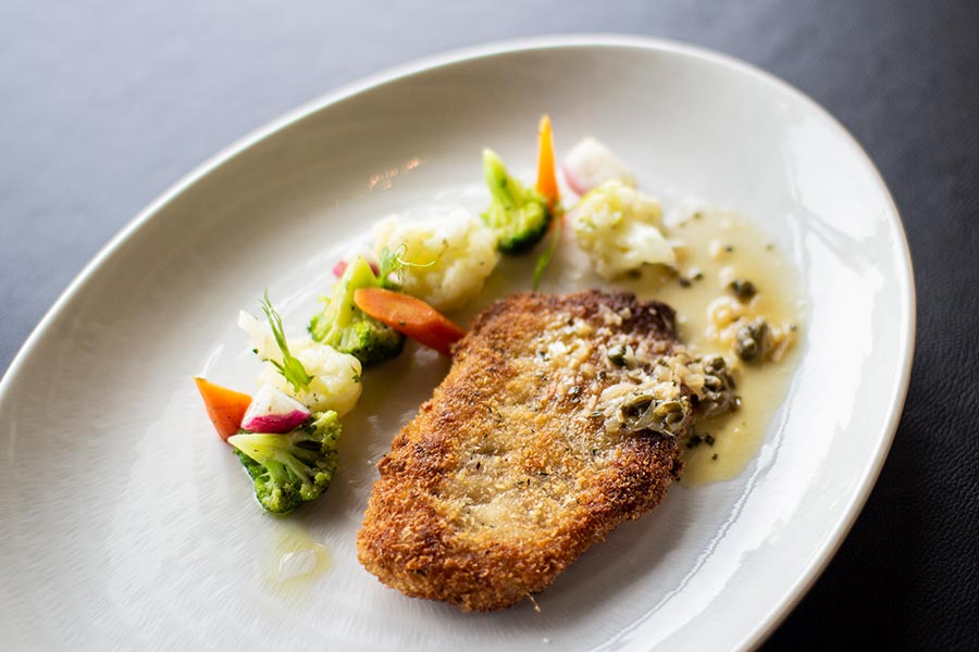 Lemon sole fish Milanese style served with sautéed vegetables & lemon