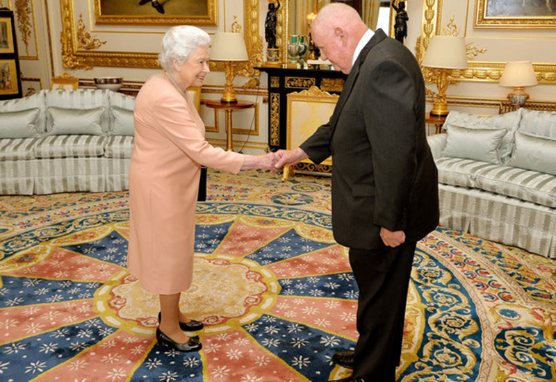 Queen Elizabeth II presenting John Mars with an honorary knighthood in  2017