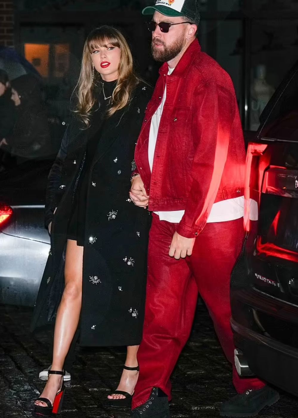 Taylor in her cosy statement coat and Travis in co-ords.