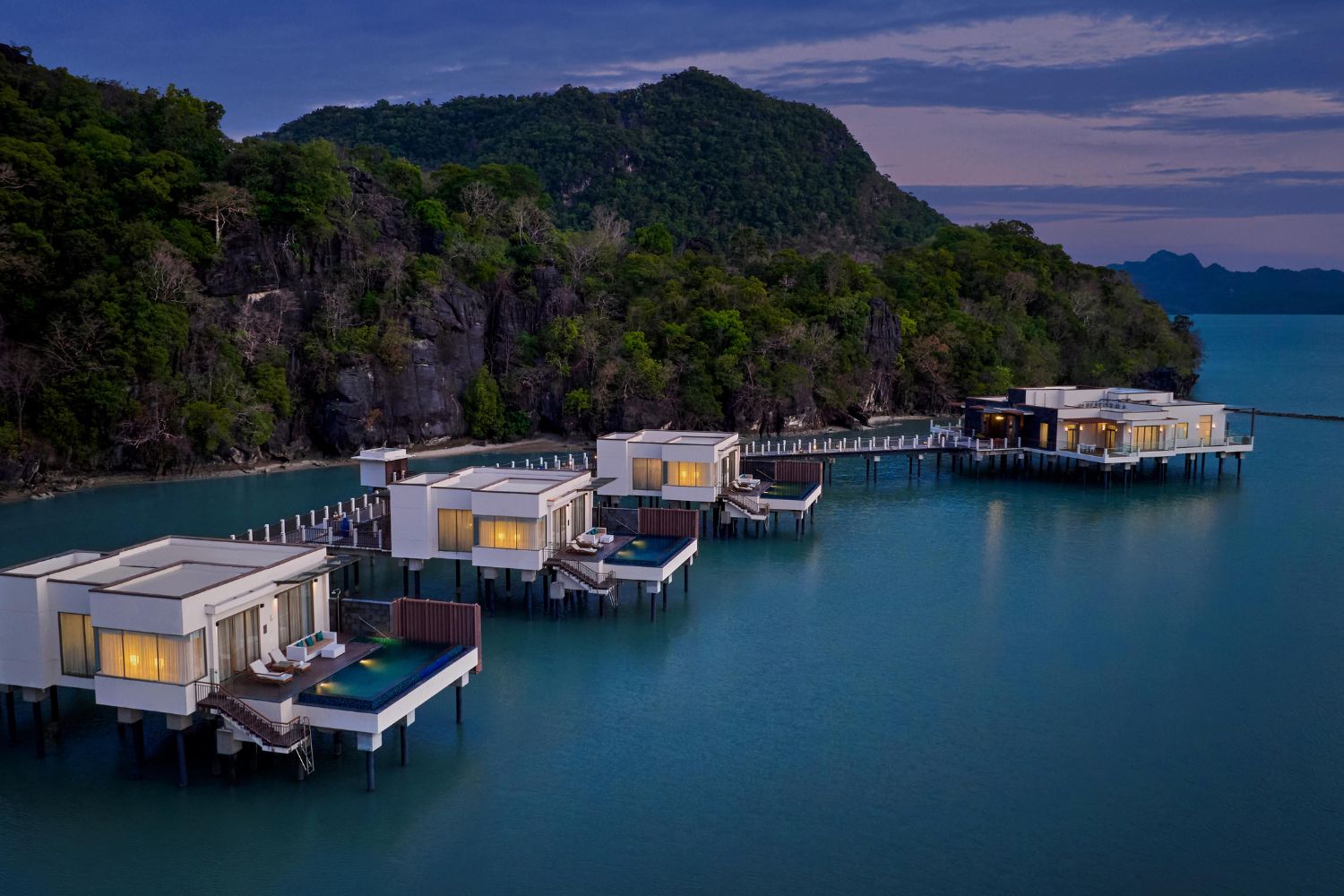 Four beautiful overwater villas rest at the foot of the hill.
